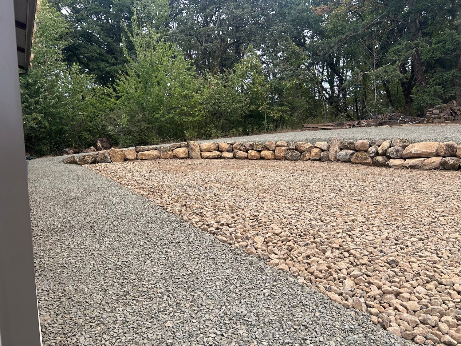 Close view of the finished boulder wall and the gravel it retains.